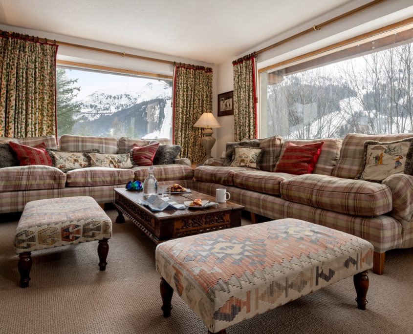 Chalet Loden's living room with comfy sofas and views over Meribel