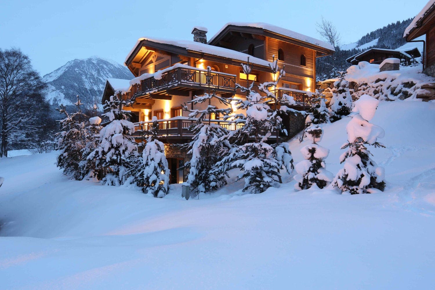 courchevel chalet in the evening surrounded by snow