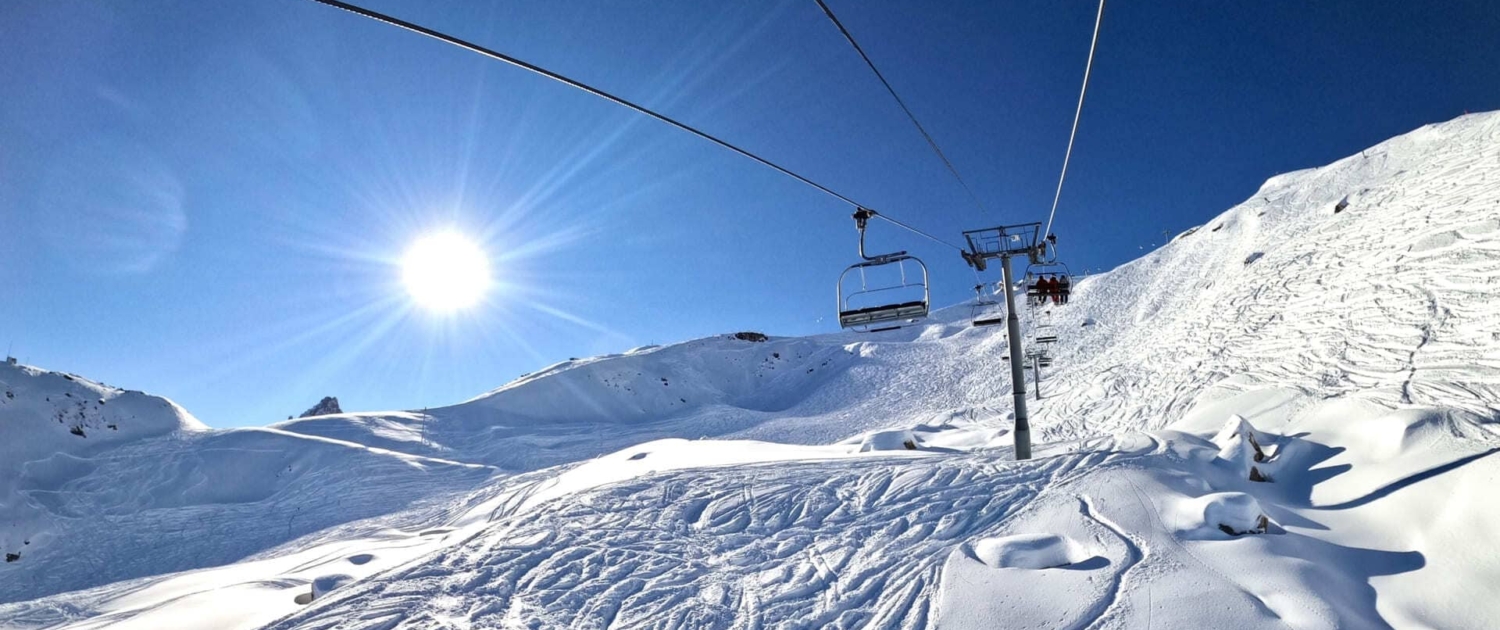 Book your ski holiday. Snowy slopes and a chairlift in Courchevel