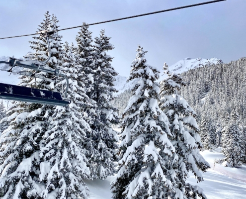 Skiing in Courchevel among the forest of Le Praz