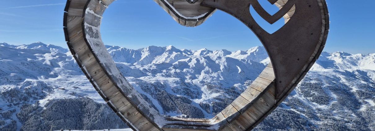 Meribel Centre: Your Guide to the Heart of the Three Valleys 1 Meribel heart sculpture seat with snowy mountains in the background