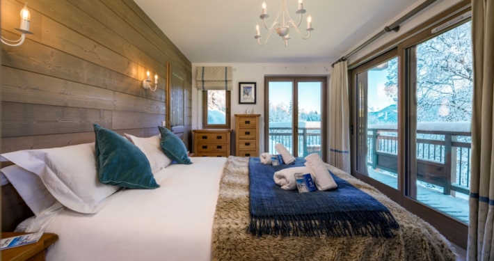 Bedroom of Chalet Caroline in La Tania showing beautiful mountain views from balcony windows