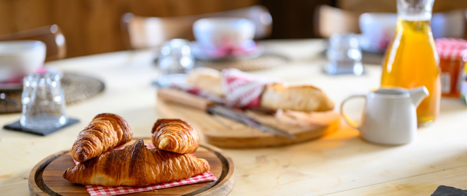 Breakfast with croissants, baguettes, juice and coffee in a ski chalet in La Tania