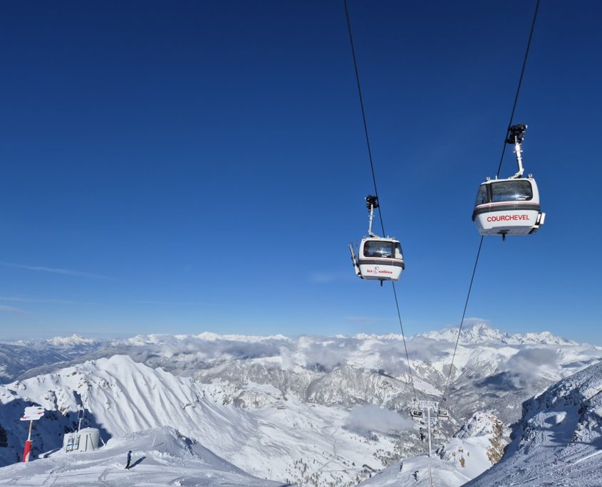 Bubble lift in Courchevel, France, snow-capped mountains in the background