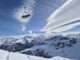 picture of snowy mountains in the ski resort of courchevel with a chairlift in the foreground