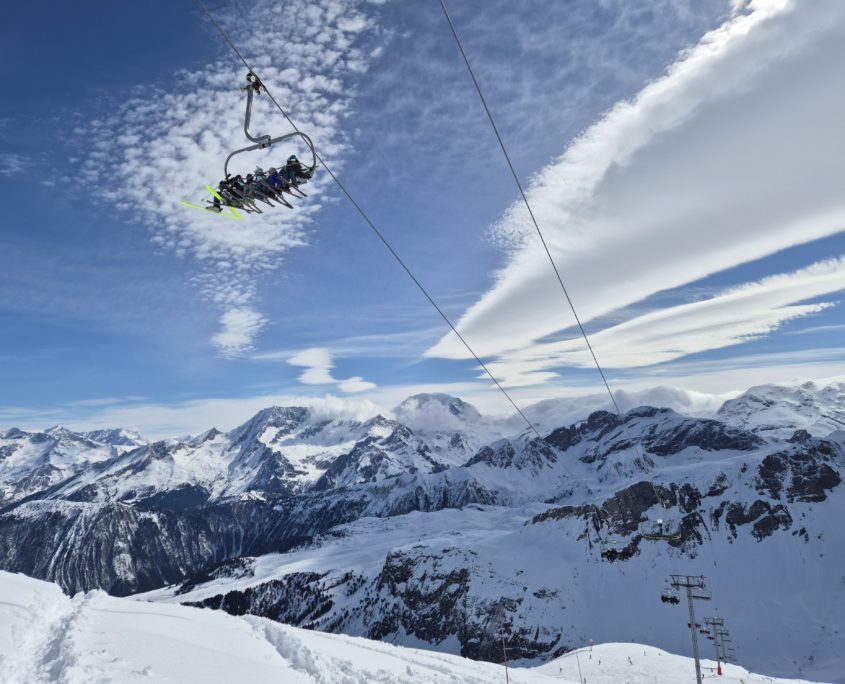 picture of snowy mountains in the ski resort of courchevel with a chairlift in the foreground